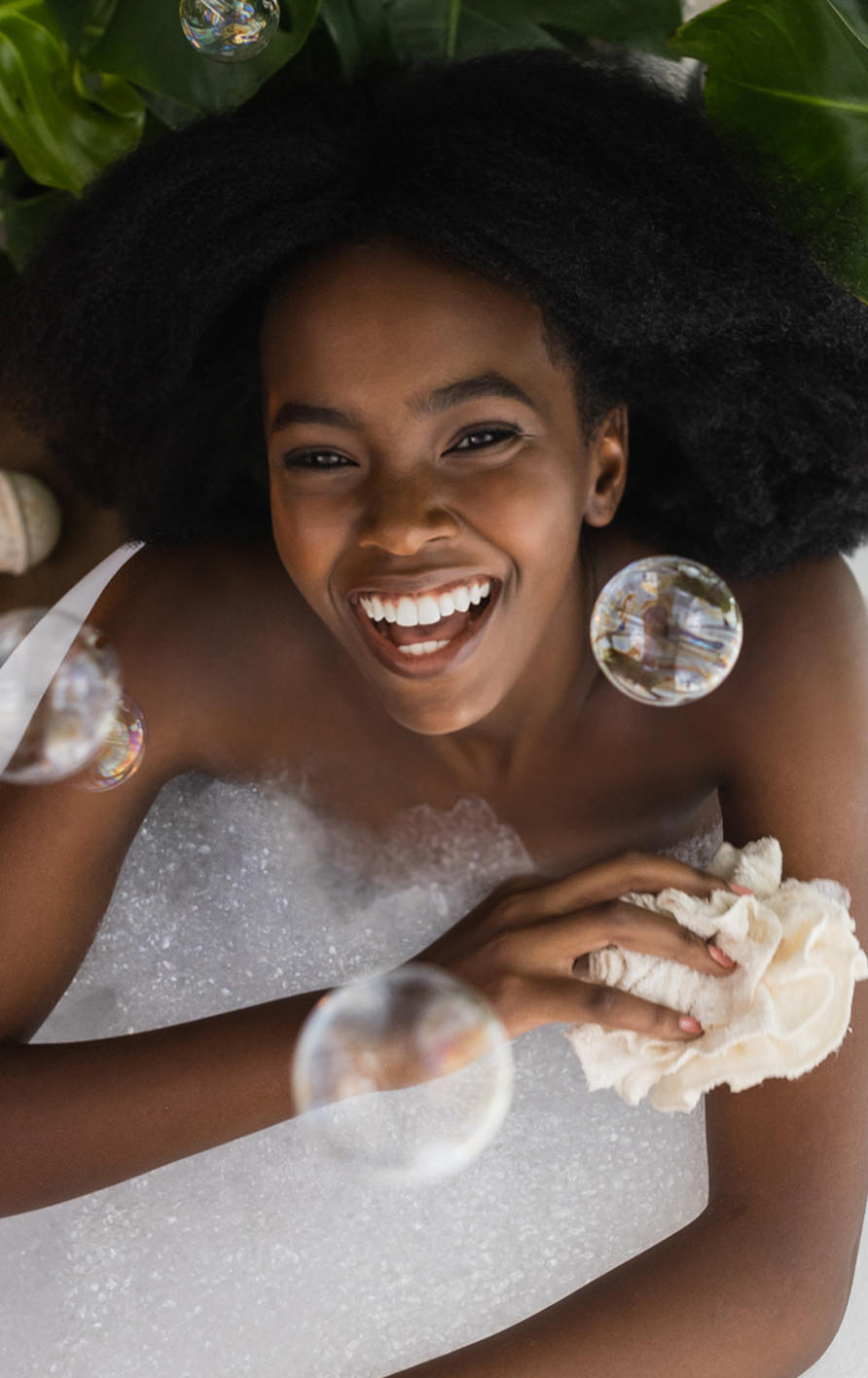 a woman enjoying a bubble bath, with bubbles floating in the air