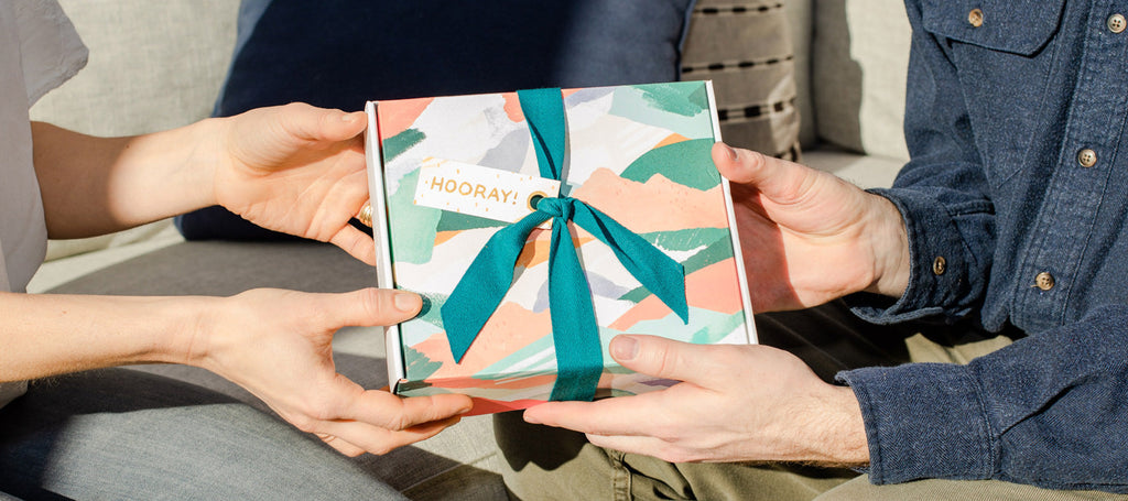 Two people exchange an all-natural, made in Canada gift set from Rocky Mountain Soap Company this holiday season.
