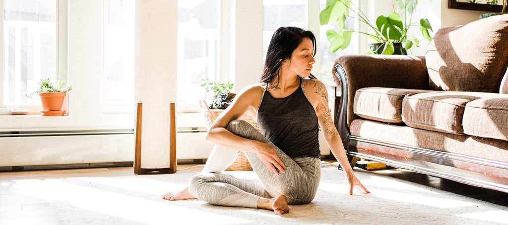 woman practicing yoga in her living room.