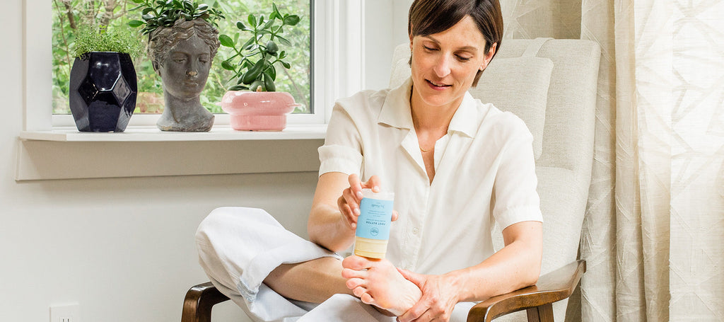 Co-founder and CEO Karina Birch applying foot butter to her feet.