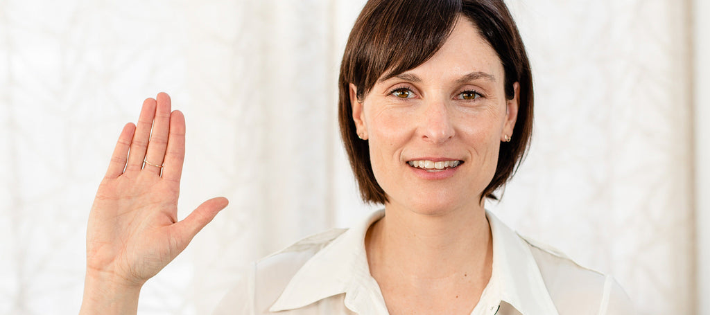 image of woman holding hand in air for women's day.