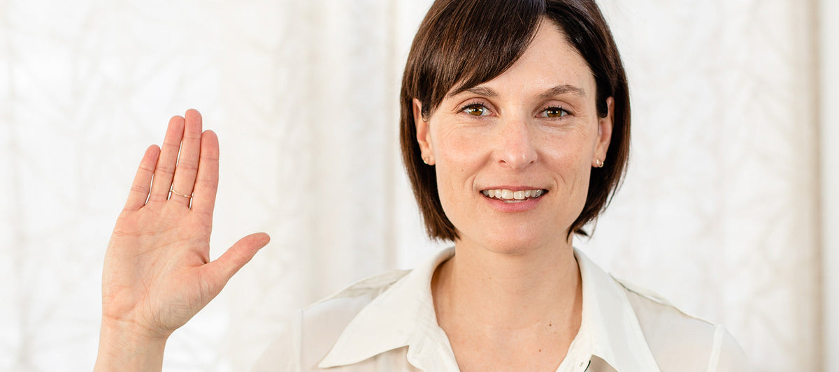 image of woman holding hand in air for women's day.