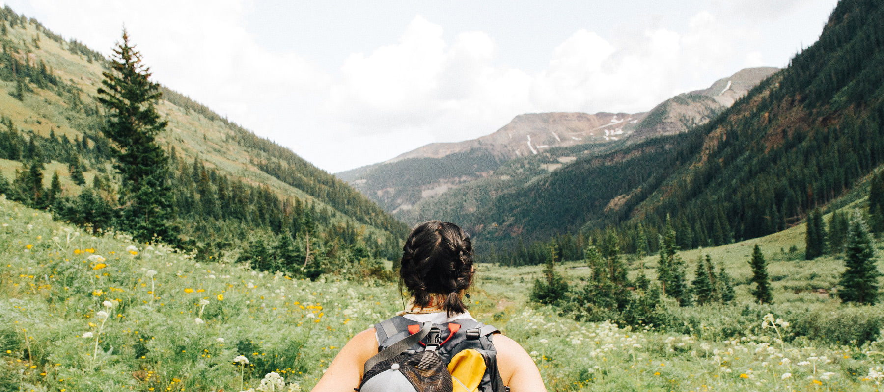 woman with a backpack hiking in the mountains