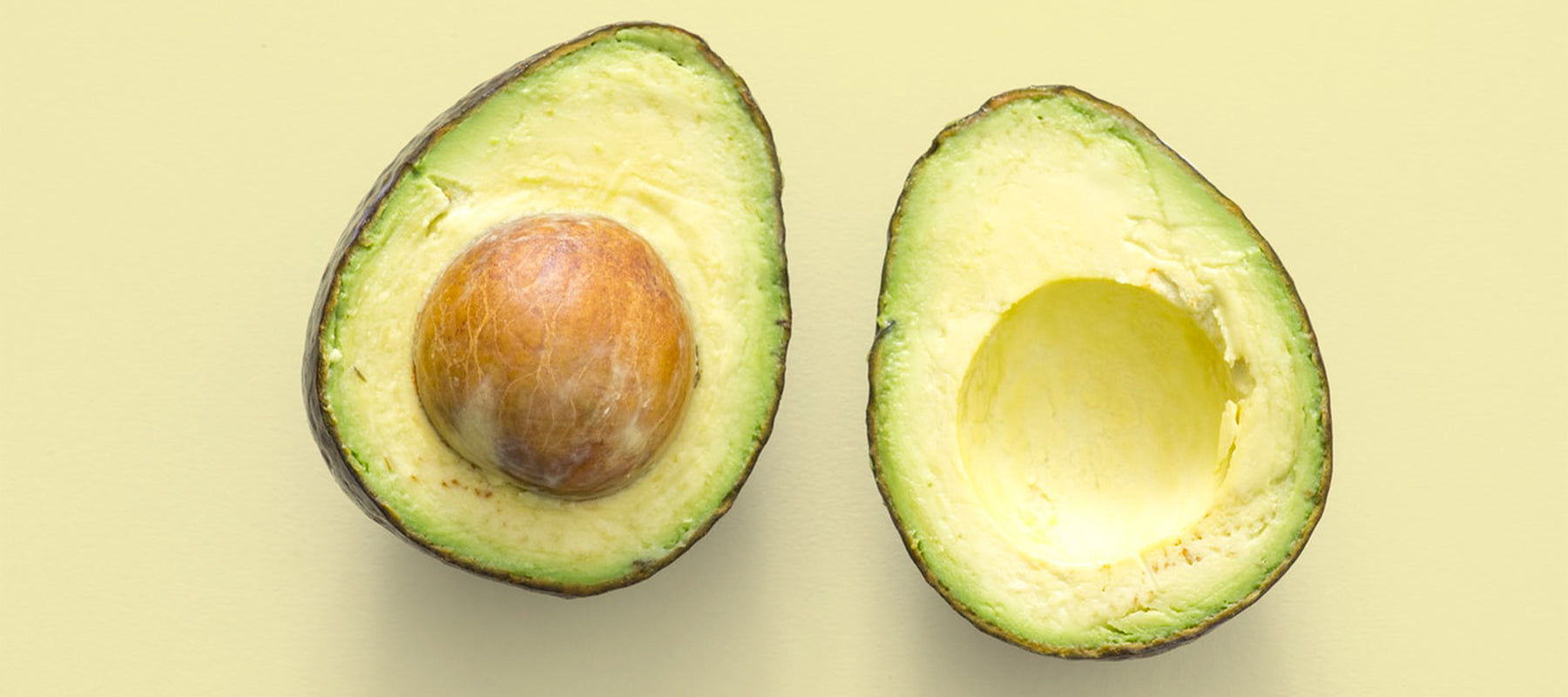 Image of an avocado sliced in two. 