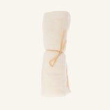 Relaxus Bamboo Face Cloth made of organic bamboo cotton, rolled and tied with a thin string.
