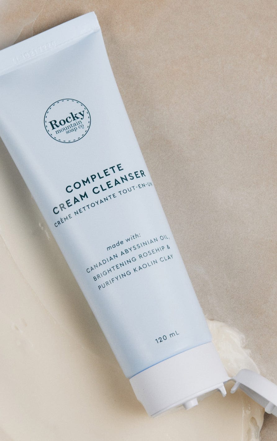 container of complete cream cleanser resting with the lid open