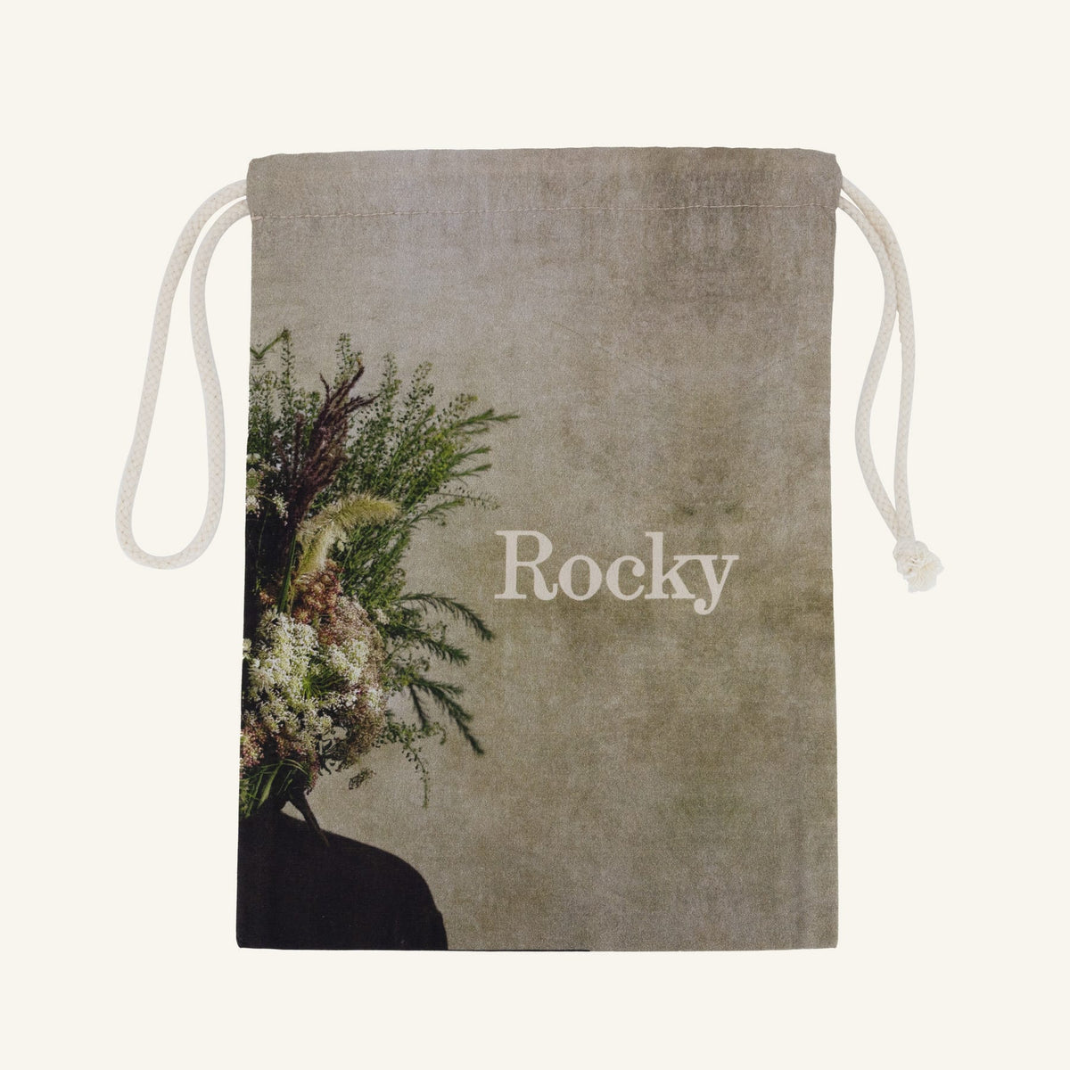 Large drawstring bag with floral design and 'Rocky' branding on a beige background