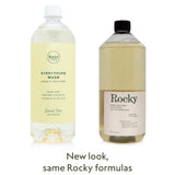 Two large plastic bottles of the Scent Free Everything Wash Bundle, one with a yellow label and white cap, and one with a cream label and black cap, side by side above the text New look, same Rocky formulas.