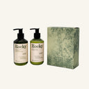 The Perfect Pair | Lemongrass set featuring two pump bottles of soap and lotion next to their matching green decorative gift box.