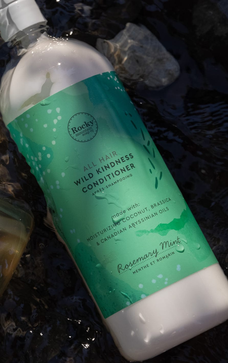 a conditioner bottle lying down in an outdoor stream