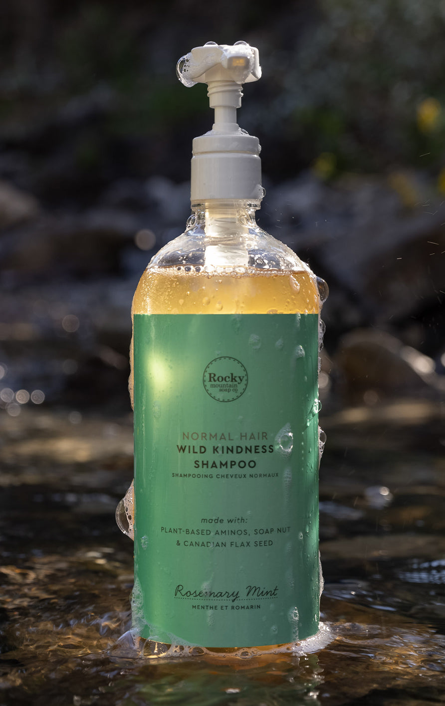 a shampoo bottle resting in an outdoor stream