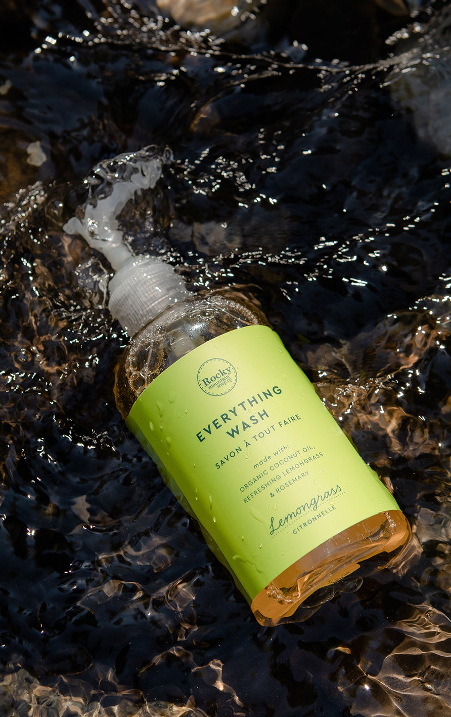 a bottle of everything wash resting in shallow water