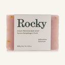 Geranium Soap: a 100g pink handcrafted, cold-process bar with geranium. Partially wrapped in a white label featuring product details in English and French.
