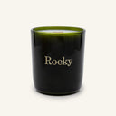 Dark green Freedom Candle with the word Rocky printed on the front.