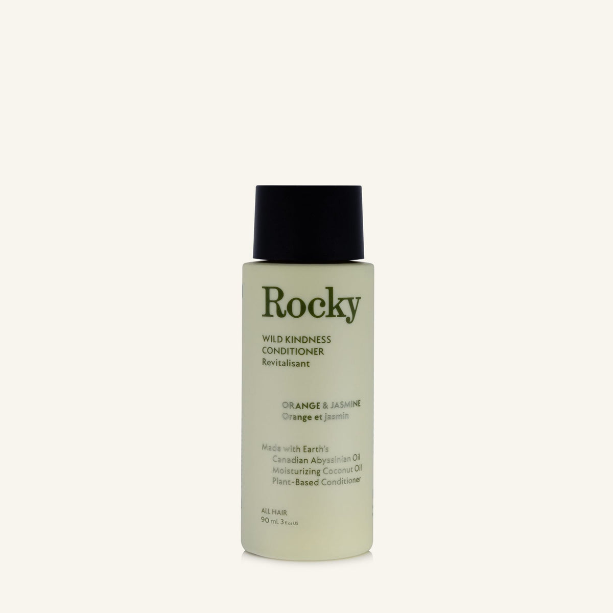 A 90ml bottle of Rocky Wild Kindness Conditioner in Orange & Jasmine scent, featuring a pale yellow-green bottle and a black cap, set against a solid off-white background.