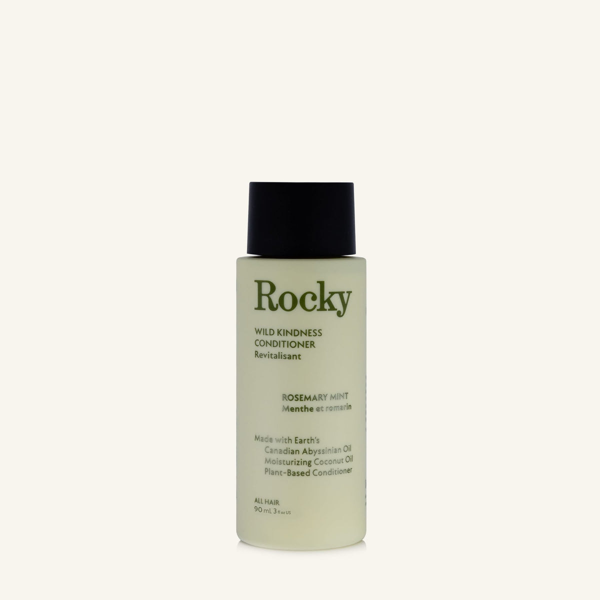 A bottle of Rocky Wild Kindness Conditioner in Rosemary Mint scent, featuring a pale yellow-green translucent bottle, dark green text, and a black cap, set against a solid off-white background.
