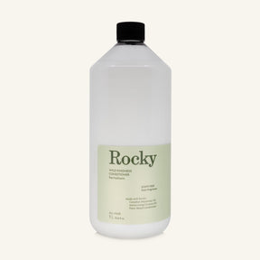 A 1L bottle of Rocky Wild Kindness Scent Free Conditioner with a black cap and a pale green label, centered on a light cream background.