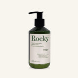 A green plastic bottle of Rocky Mountain Soap Company Lemongrass Everything Wash with a black pump dispenser and a label detailing the ingredients.
