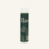 A cylindrical Rocky Mountain Soap Company Vanilla Coconut Lip Butter tube with a green label featuring white text in English and French, including a QR code.
