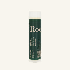 A cylindrical Rocky Mountain Soap Company Vanilla Coconut Lip Butter tube with a green label featuring white text in English and French, including a QR code.