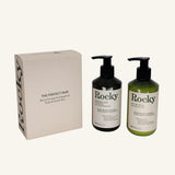 The Perfect Pair gift set in Blood Orange & Grapefruit scent featuring a beige box and two pump bottles (Rocky everything wash and oat body lotion) in black and green, on a light cream background.