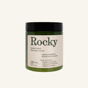 A dark green jar of Rocky Mountain Soap Company Vanilla Coconut Sugar Scrub with a black lid and a cream-colored label detailing product ingredients and volume.