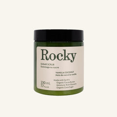 A dark green jar of Rocky Mountain Soap Company Vanilla Coconut Sugar Scrub with a black lid and a cream-colored label detailing product ingredients and volume.