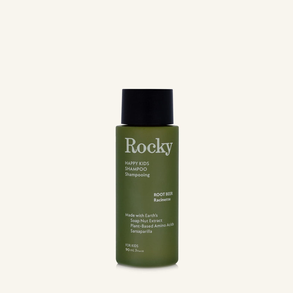A 90ml bottle of Rocky Happy Kids Shampoo in Root Beer, featuring an olive green bottle and a black cap, centered on a light cream background.