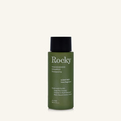 A 90ml bottle of Rocky Wild Kindness Shampoo in scent free for normal hair, featuring an olive green bottle and a black cap, centered on a light cream background.