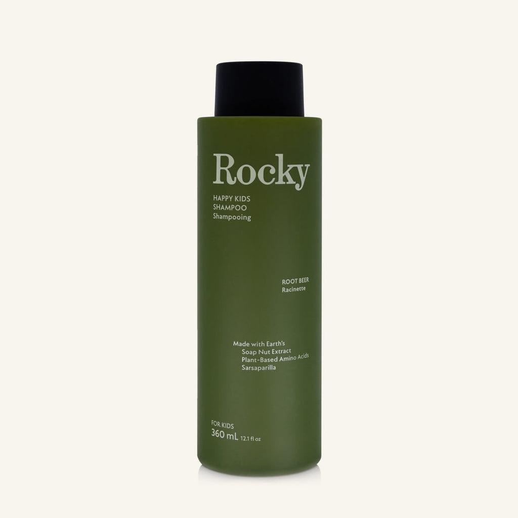A 360ml bottle of Rocky Happy Kids Shampoo in Root Beer, featuring an olive green bottle and a black cap, centered on a light cream background.