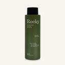A 360ml bottle of Rocky Wild Kindness Shampoo in scent free for normal hair, featuring an olive green bottle and a black cap, centered on a light cream background.