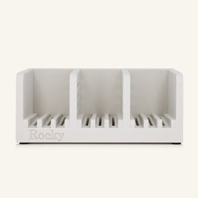 A white three-compartment soap holder with slotted bases and the name 'Rocky' embossed on the front, shown against a solid off-white background.