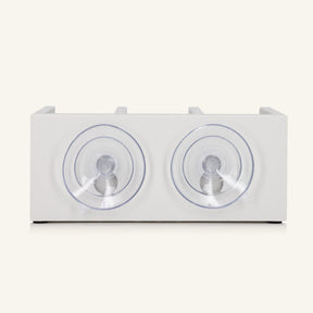 The back of the white shower shelf featuring two suction cups