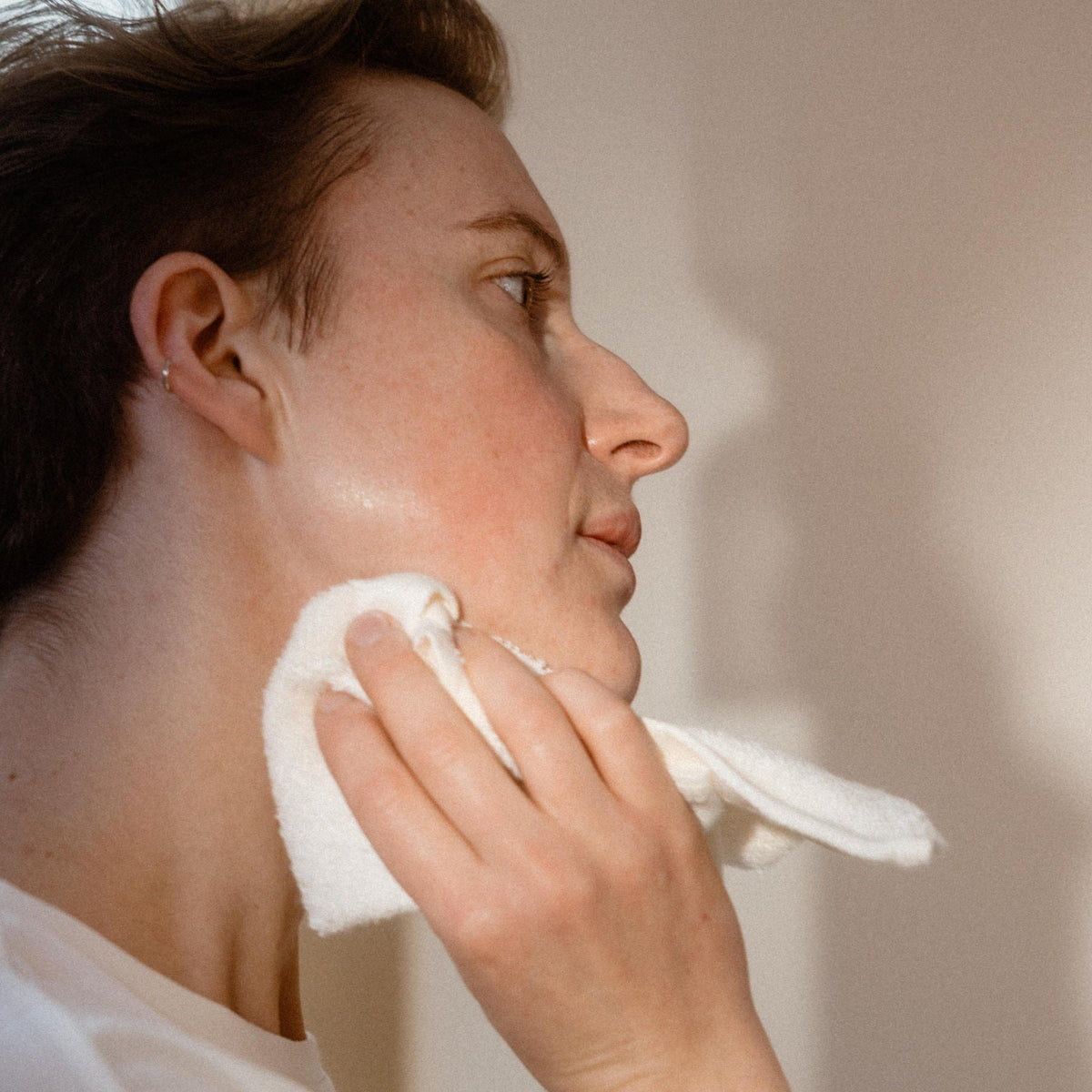 Transformative Cleansing Oil in use with washcloth