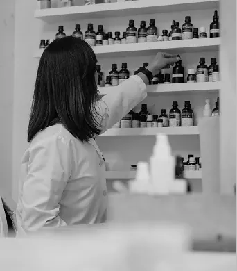 A Rocky formulator at the shelves of raw ingredient bottles in the Canmore lab