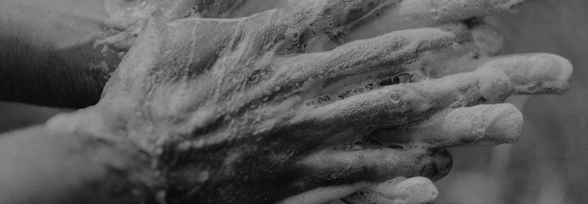 Hands lathering a bar of Rocky Mountain Soap