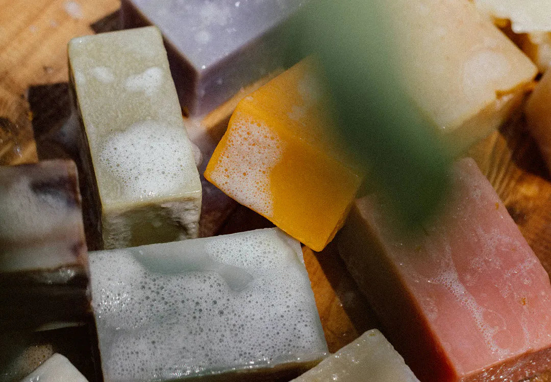 A pile of lathered bar soaps in assorted scents