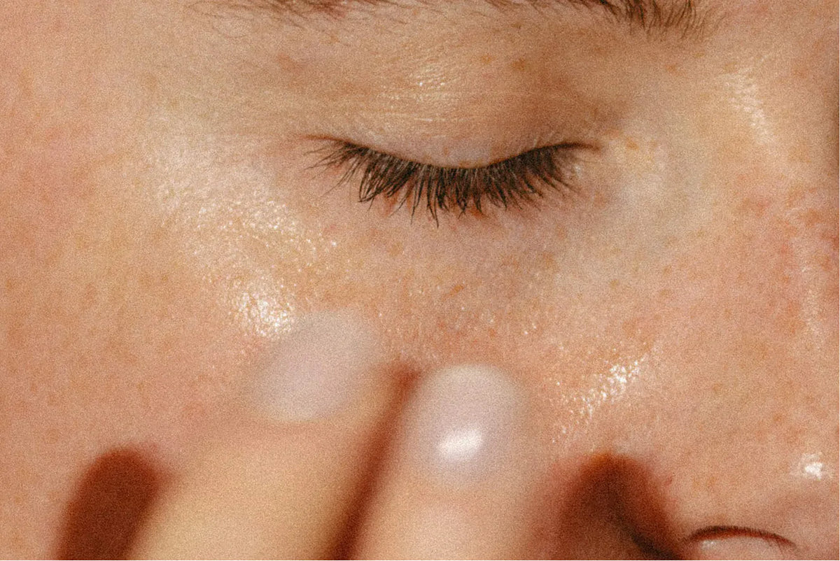 Face cream smoothed onto the cheekbone, close up