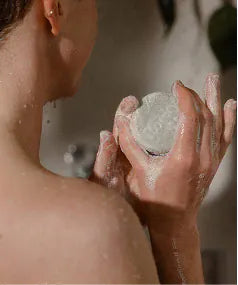 A Hair Bar held at the shoulder in the shower